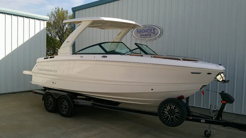 The Image of A sleek, modern boat on a trailer in front of a building. - 0
