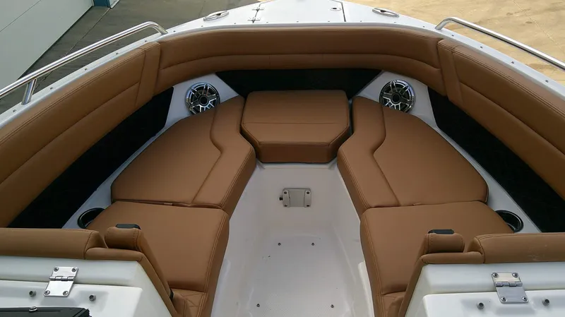 Slide: The Image of The image shows the bow area of a Chaparral SSX 6 with brown cushions and speakers. - 19