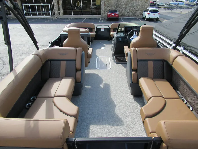Slide: The Image of The image shows the interior of a 2026 Bennington 22 MFB with luxurious brown seating. - 6