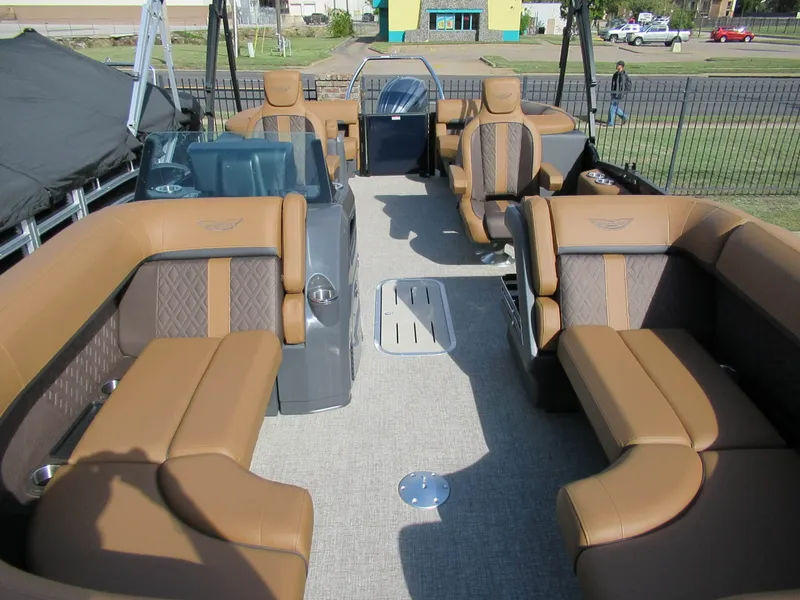 Slide: The Image of Interior view of a Bennington 22 MFB pontoon boat with luxurious brown seating and carpeted floor. - 7