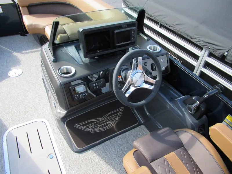 Slide: The Image of The cockpit of a 2026 Bennington 22 MFB with a modern steering wheel and controls. - 2