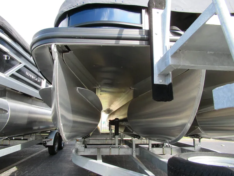 Slide: The Image of Underside view of a Bennington 22 MFB pontoon boat on a trailer, showing the aluminum hulls. - 11