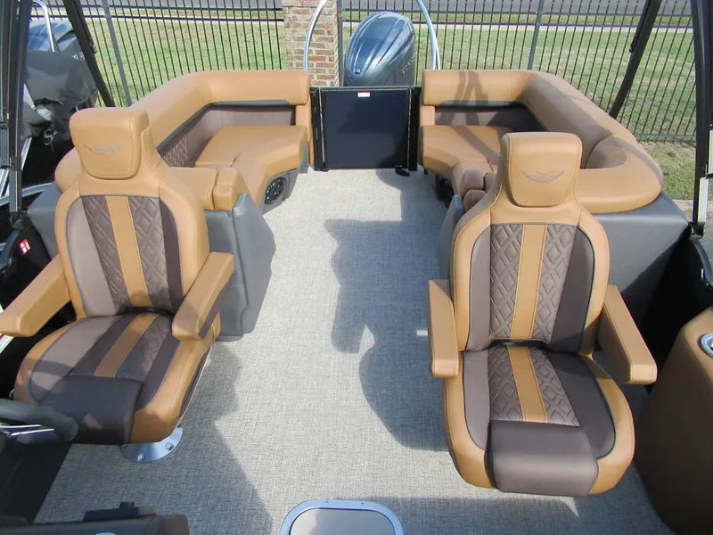 Slide: The Image of Interior of a 2026 Bennington 22 MFB with luxurious brown seating. - 4