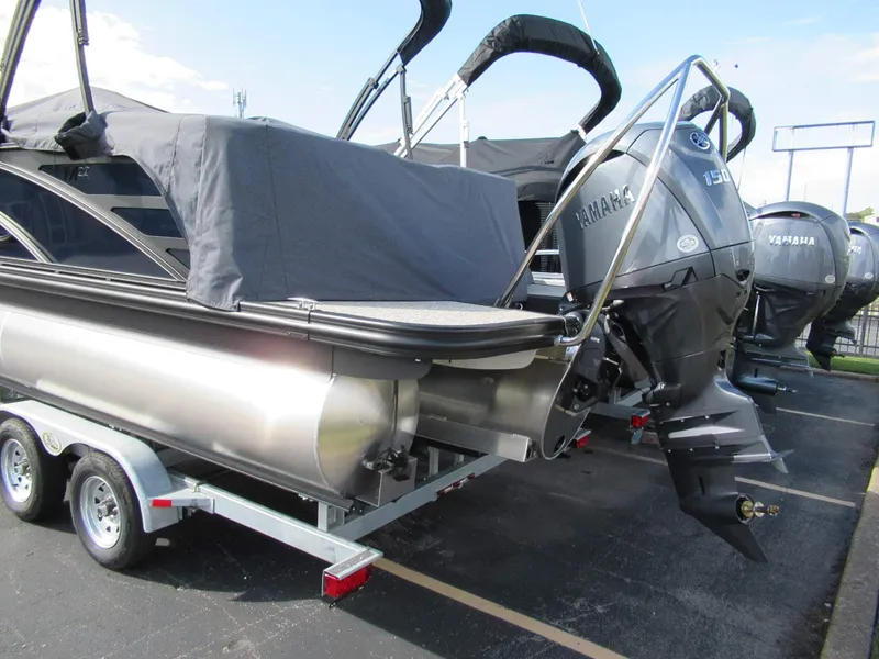 Slide: The Image of A 2026 Bennington 22 MFB pontoon boat on a trailer with a Yamaha outboard motor. - 9