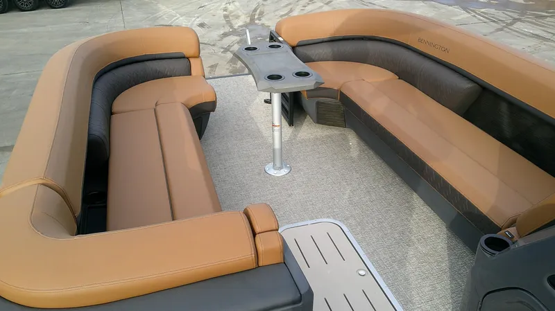 Slide: The Image of The image shows the seating areas of a Bennington M 26 boat with brown upholstery. - 11