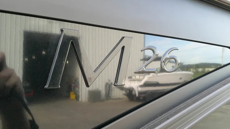 Slide: The Image of Close-up of the "M 26" lettering on a boat, with a building in the background. - 9