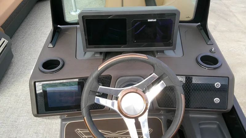 Slide: The Image of The image shows the helm of a 2027 Bennington M 26 boat with modern instruments. - 18