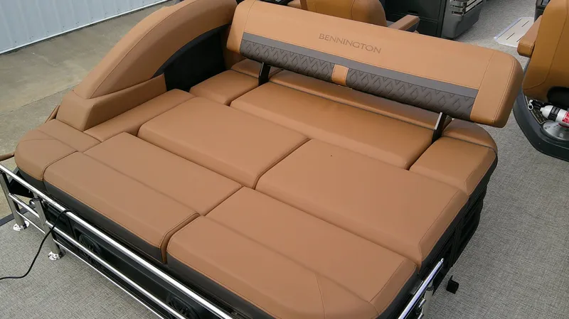 Slide: The Image of The image shows a luxurious brown lounging area on a Bennington M 26 boat. - 21