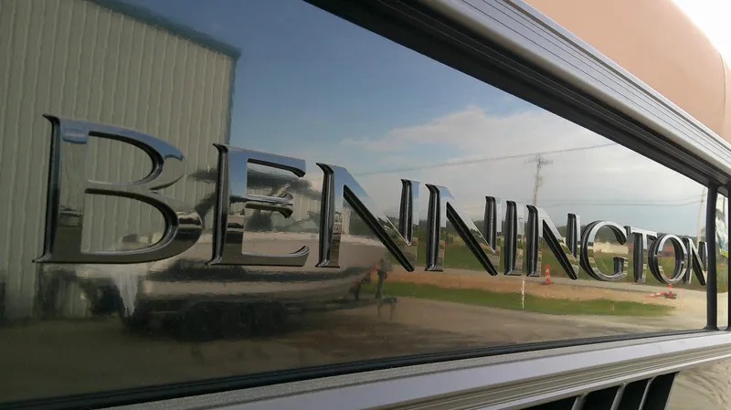 Slide: The Image of Close-up of the Bennington logo on a shiny boat hull. - 8