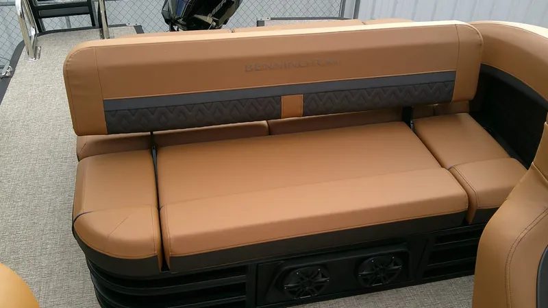 Slide: The Image of The image shows a luxurious, cushioned bench seat on a Bennington M 26 boat. - 20