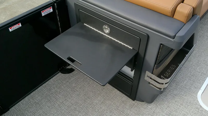 Slide: The Image of A fold-out table in a Bennington M 26 boat, surrounded by cushioned seating. - 14