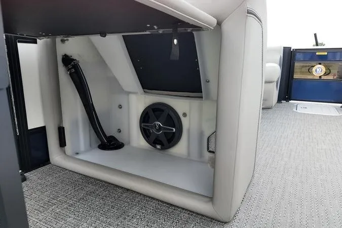 Slide: The Image of Interior view of 2025 Barletta LUSSO 25UCAT boat, featuring storage compartment and speaker. - 16
