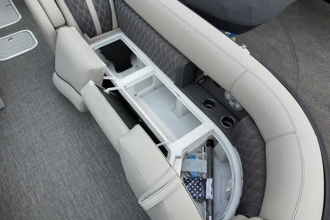 Slide: The Image of 2025 Barletta LUSSO 25UCAT boat interior with open storage compartment and cup holders. - 3
