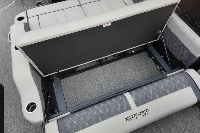 Slide: The Image of 2025 Barletta LUSSO 25UCAT boat interior with open storage compartment and cushioned seating. - 19