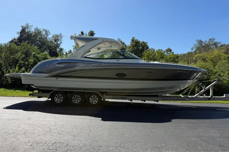 Slide: The Image of 2020 Formula 350 Crossover Bowrider on trailer, parked outdoors. - 6