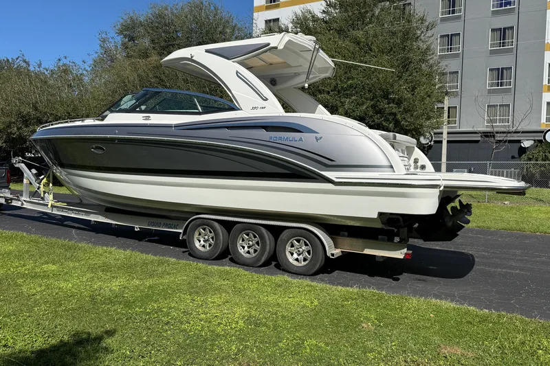 The Image of 2020 Formula 350 Crossover Bowrider on trailer, parked outdoors near building. - 0