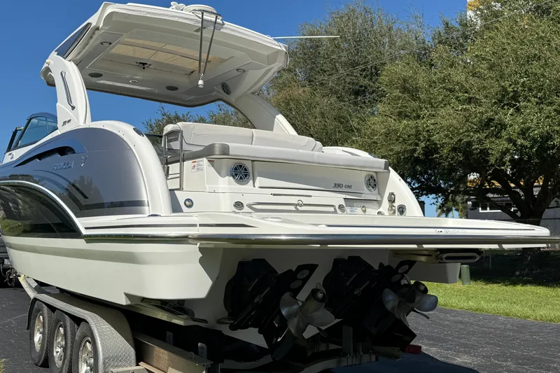 Slide: The Image of 2020 Formula 350 Crossover Bowrider on trailer, rear view with trees in background. - 9