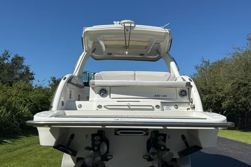 Slide: The Image of 2020 Formula 350 Crossover Bowrider boat, rear view, showcasing deck and seating area. - 8