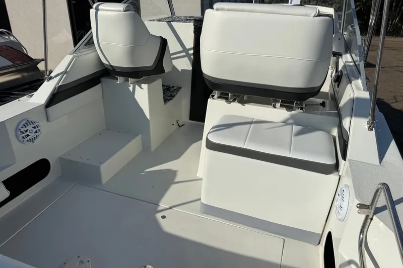 Slide: The Image of 1991 Carver 25 Montego boat interior with white seating and clean deck. - 8