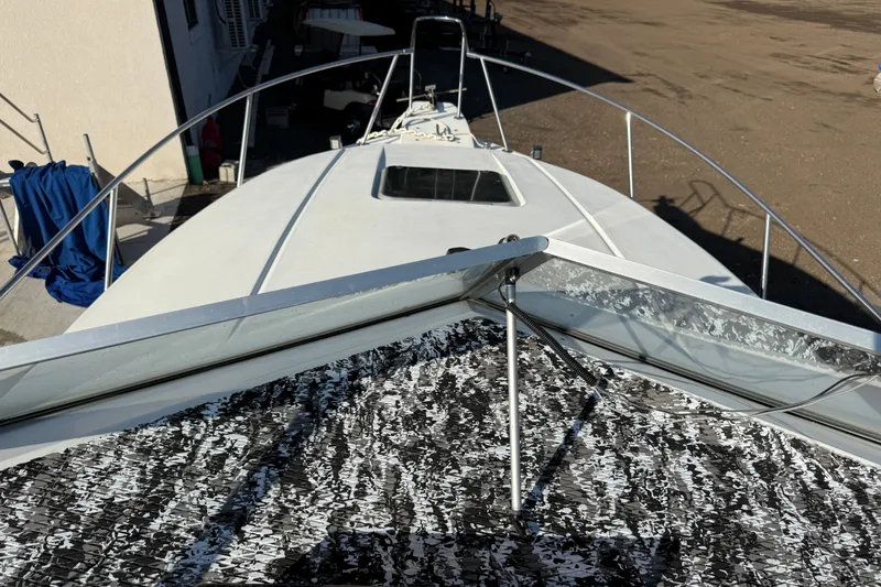 Slide: The Image of 1991 Carver 25 Montego boat deck view with railing and hatch. - 4
