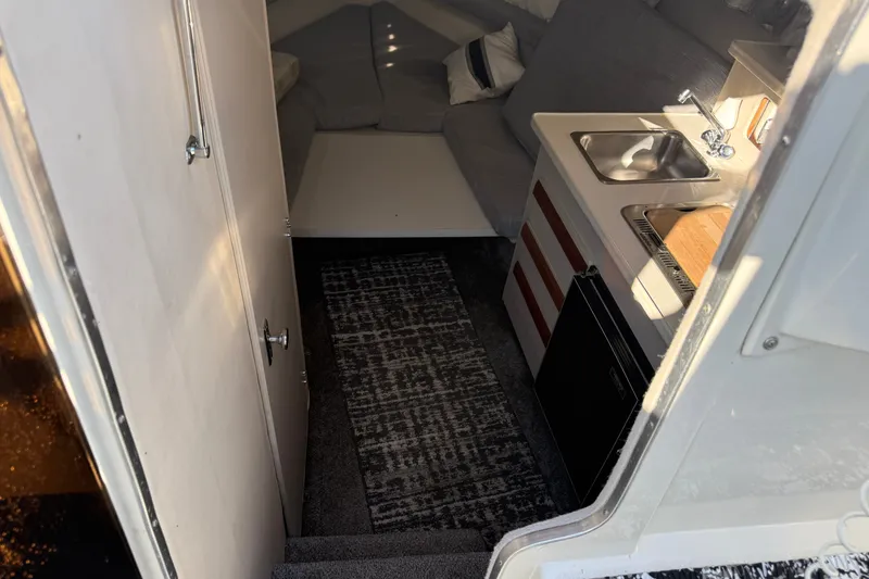 Slide: The Image of Interior of 1991 Carver 25 Montego boat with kitchenette and seating area. - 11