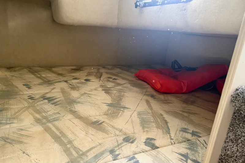 Slide: The Image of Interior cabin of 1991 Carver 25 Montego boat with patterned flooring and red life jacket. - 14