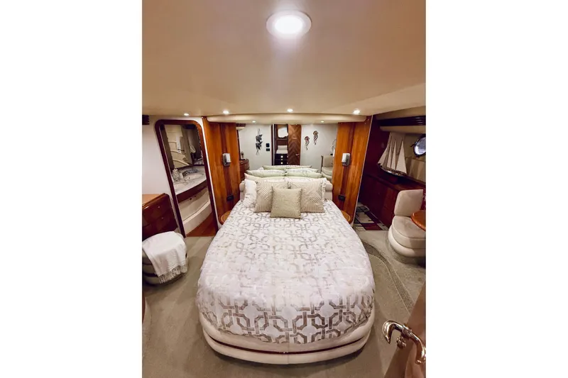 Slide: The Image of Luxurious bedroom interior of 2007 Azimut 68E yacht with elegant bedding and wood accents. - 48