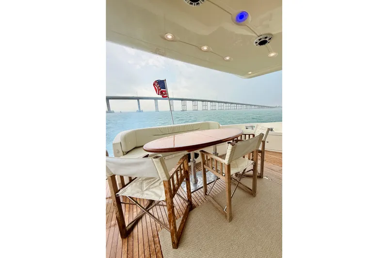 Slide: The Image of Outdoor seating on 2007 Azimut 68E yacht with ocean view and bridge in background. - 63
