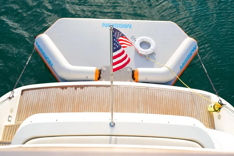 Slide: The Image of Azimut 68E 2007 yacht with American flag and inflatable platform on water. - 85