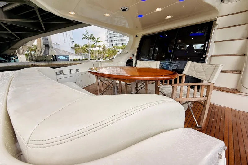 Slide: The Image of Luxurious 2007 Azimut 68E yacht deck with elegant seating and wooden table. - 65