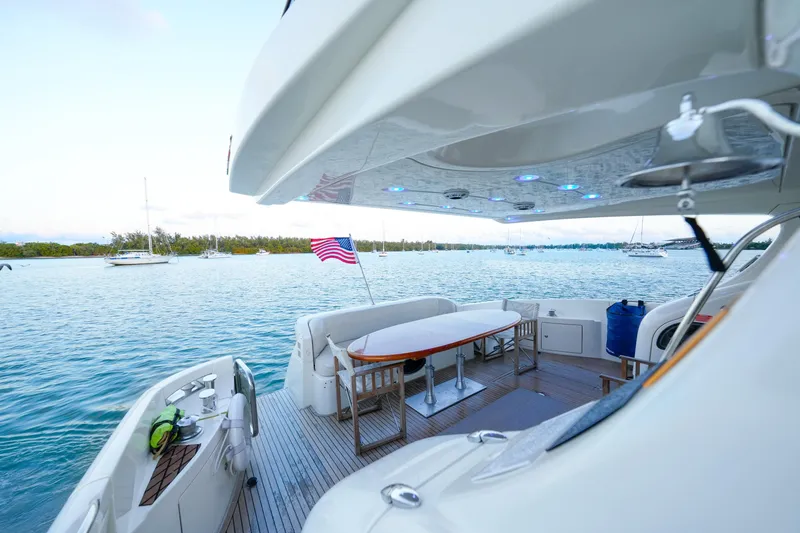 Slide: The Image of Luxurious 2007 Azimut 68E yacht deck with ocean view and American flag. - 59