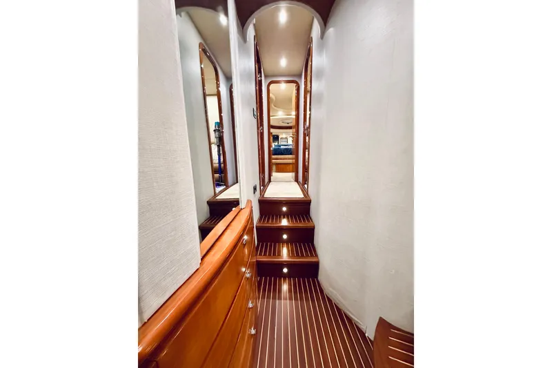 Slide: The Image of Luxurious interior of 2007 Azimut 68E yacht with elegant wooden staircase and ambient lighting. - 36
