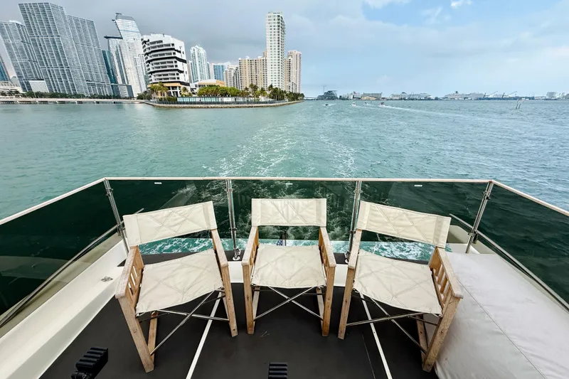 Slide: The Image of Azimut 68E yacht deck with chairs, city skyline view, 2007 model. - 80