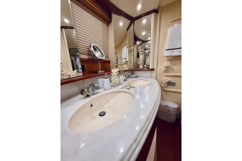 Slide: The Image of Luxurious bathroom in 2007 Azimut 68E yacht with dual sinks and elegant decor. - 56
