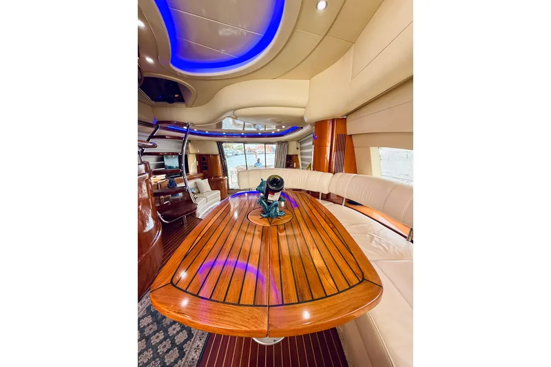 Slide: The Image of Luxurious interior of 2007 Azimut 68E yacht with elegant wood table and ambient lighting. - 23