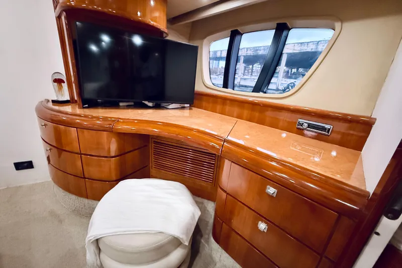 Slide: The Image of Luxurious interior of 2007 Azimut 68E yacht with elegant wood cabinetry and modern TV setup. - 52