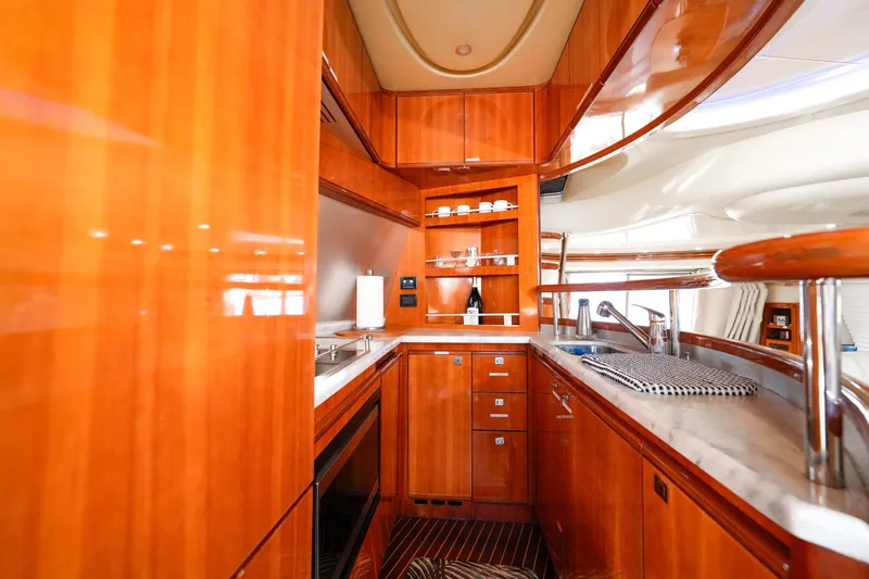 Slide: The Image of Luxurious wooden interior of 2007 Azimut 68E yacht kitchen with modern amenities. - 26