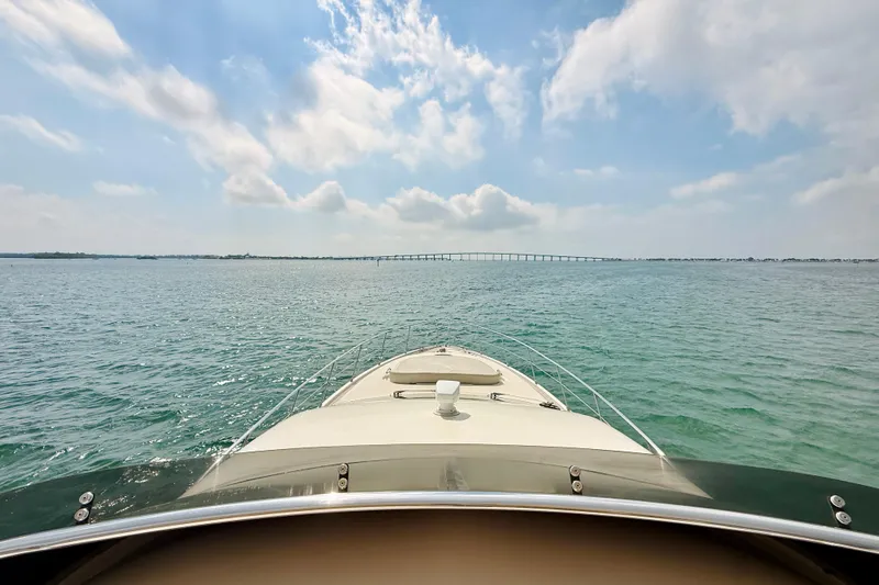 Slide: The Image of Bow view of 2007 Azimut 68E yacht cruising under a blue sky. - 84