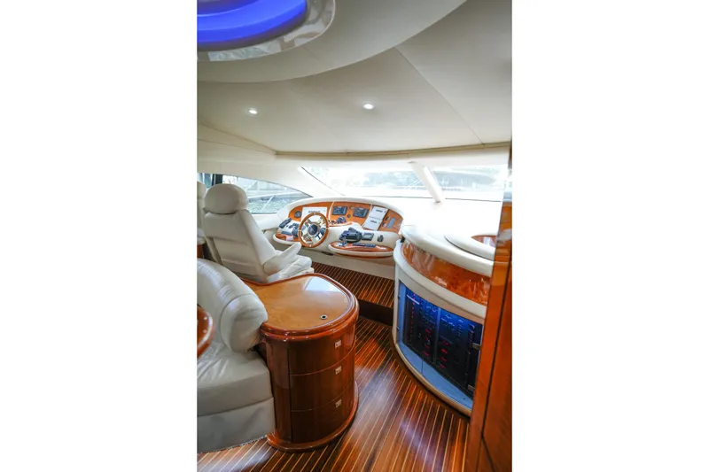 Slide: The Image of Luxurious interior of 2007 Azimut 68E yacht with elegant wood finishes and modern controls. - 29