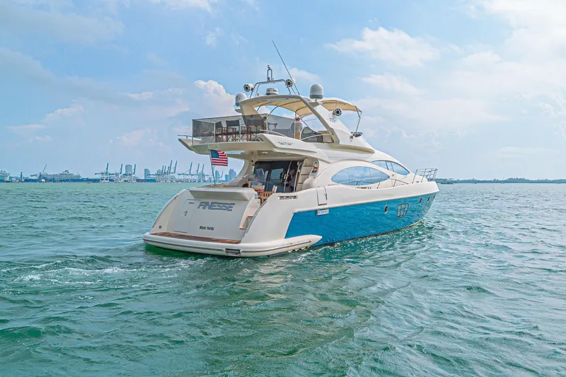 Slide: The Image of 2007 Azimut 68E yacht cruising on open water under a clear sky. - 6