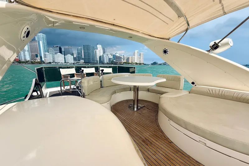 Slide: The Image of Luxurious 2007 Azimut 68E yacht with city skyline view, featuring elegant outdoor seating. - 78