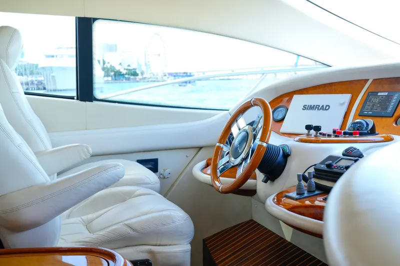 Slide: The Image of Luxurious 2007 Azimut 68E yacht helm with leather seating and advanced navigation controls. - 31