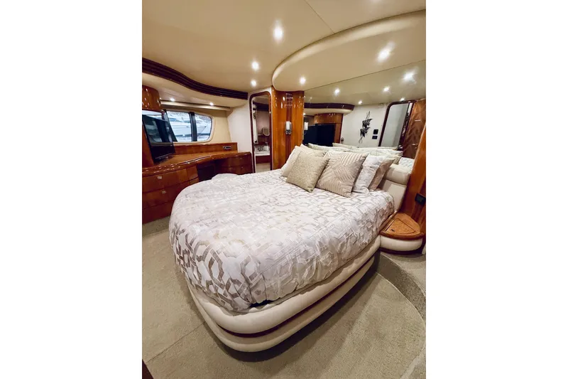 Slide: The Image of Luxurious bedroom interior of a 2007 Azimut 68E yacht with elegant bedding and wood finishes. - 49