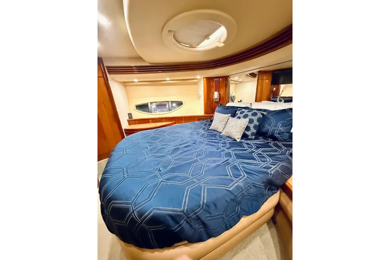 Slide: The Image of Luxurious bedroom interior of 2007 Azimut 68E yacht with elegant bedding and wood accents. - 44
