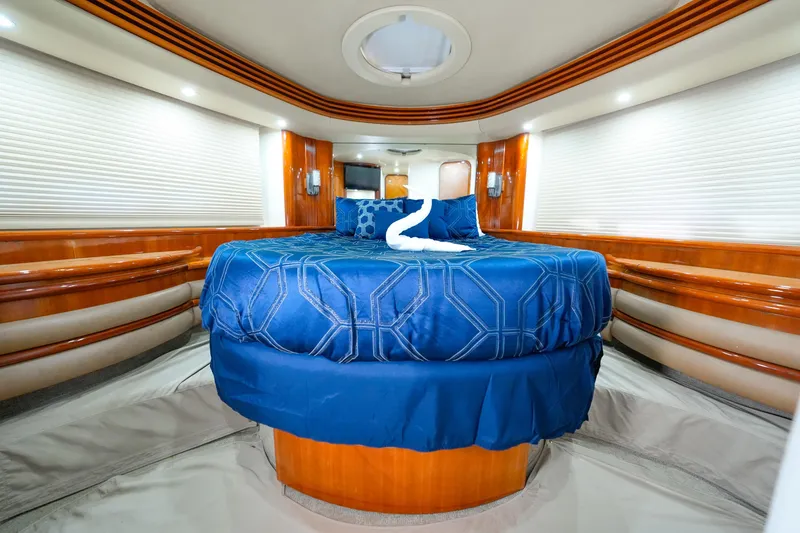 Slide: The Image of Luxurious bedroom interior of 2007 Azimut 68E yacht with elegant blue bedding. - 43