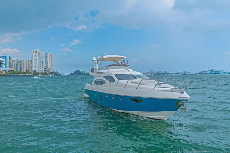 Slide: The Image of 2007 Azimut 68E yacht cruising near city skyline on a sunny day. - 3