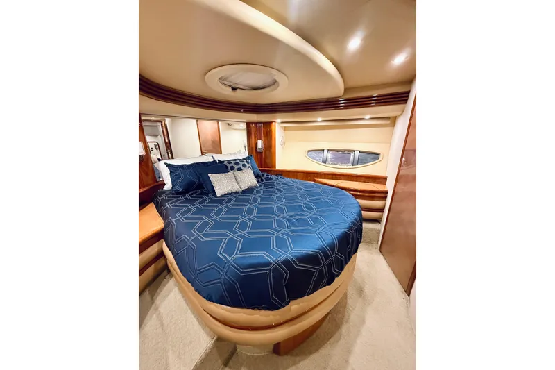 Slide: The Image of Luxurious bedroom interior of 2007 Azimut 68E yacht with elegant blue bedding. - 45