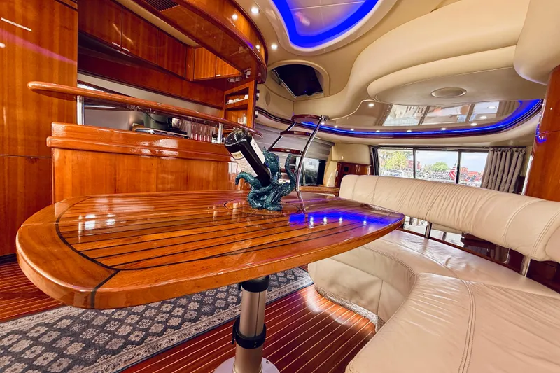 Slide: The Image of Luxurious interior of 2007 Azimut 68E yacht with elegant wood finishes and plush seating. - 22