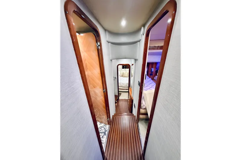 Slide: The Image of Interior hallway of 2007 Azimut 68E yacht, featuring elegant wood finishes and luxurious design. - 47