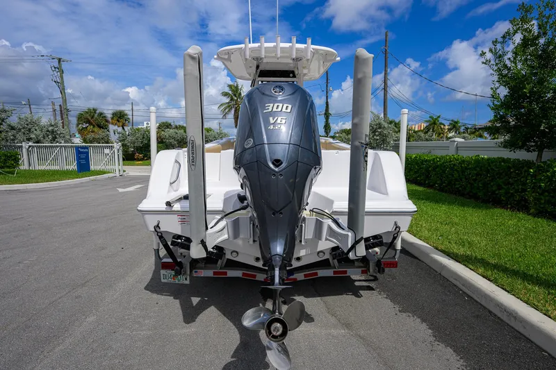 Slide: The Image of 2024 Sportsman Open 232 Center Console boat with powerful 300 V6 engine, parked outdoors. - 11